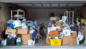 A garage unit filled with boxes that are stacked with clutter and junk