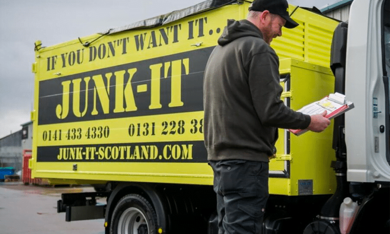 Junk-it truck with staff member holding clipboard