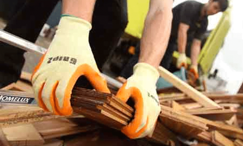 Junk-it staff removing debris with safety gloves
